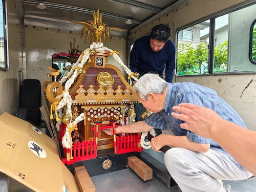 Aoki Shijegi, mikoshi shrine craftsman, prepares mikoshi shrines to be transported