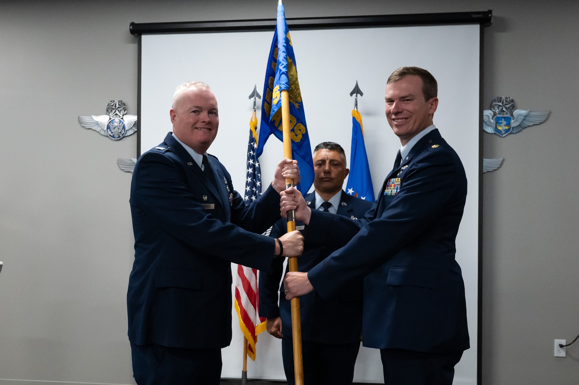 Maj. Daniel Dale (right) is the new commander of the 69th Aerial Port Squadron! Maj. Dale received command during the squadron's change of command ceremony on Aug. 3, 2025, at Joint Base Andrews. Col. Justin Cooper, 759th Logistics Readiness Flight Commander, officiated the ceremony. Maj. Dale comes to the Wing from Peterson Space Force Base, Colo., where he was the Director of Operations for the 39th Aerial Port Squadron. (U.S. Air Force photo by Senior Airman Alexcia Givens)