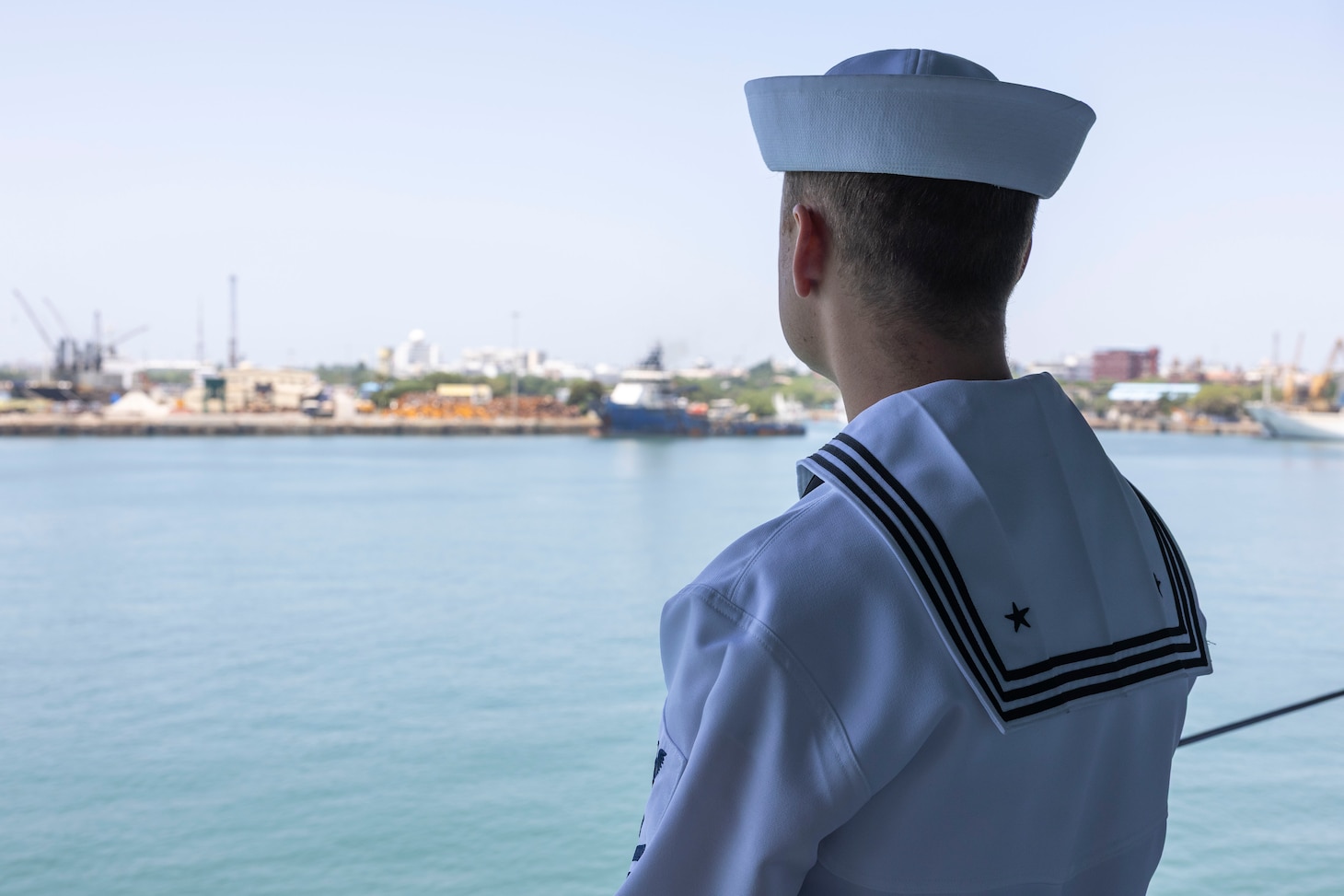 CHENNAI, India (Aug. 24, 2025) – Electrician's Mate (Nuclear) 2nd Class Noah Welk, assigned to the forward-deployed submarine tender USS Frank Cable (AS 40), mans the rails during the ship’s arrival to Chennai, India for a port visit, Aug. 24, 2025. Frank Cable is underway supporting the U.S. 7th Fleet, the U.S. Navy’s largest forward deployed numbered fleet, operating with allies and partners in preserving a free and open Indo-Pacific region. (U.S. Navy photo by Mass Communication Specialist 3rd Class Haley Wilson)