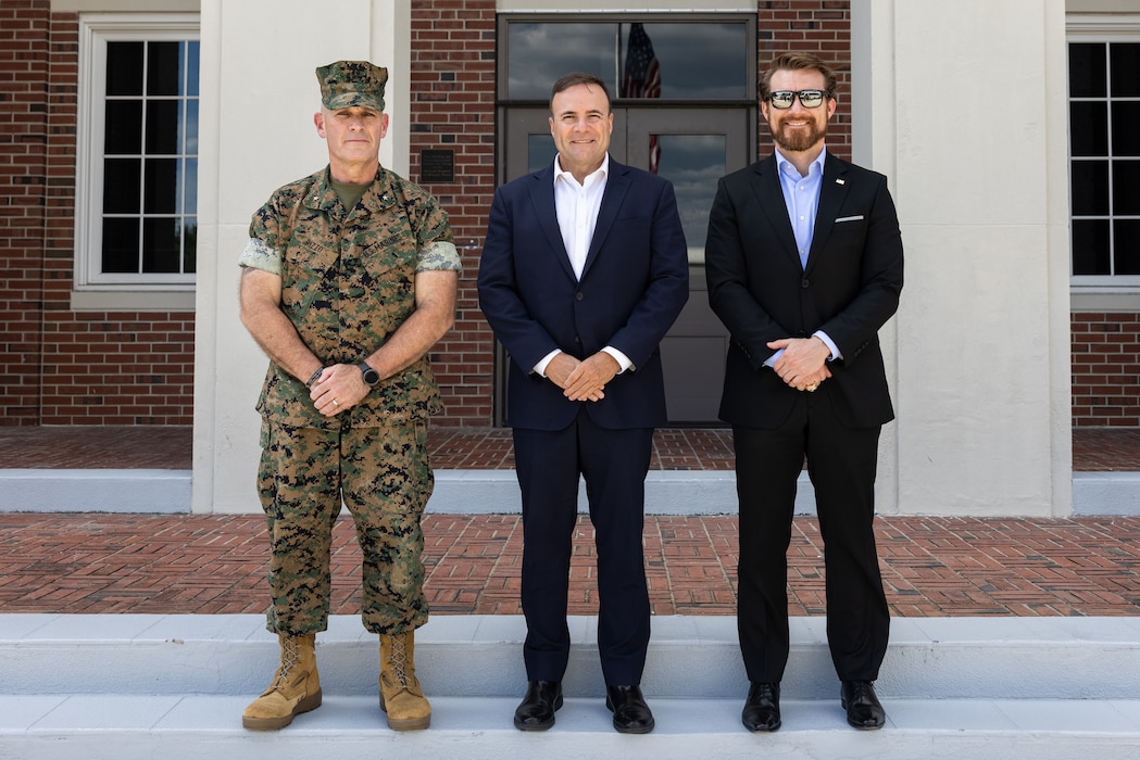 U.S. Marine Corps Brig. Gen. Ralph J. Rizzo, Jr., commanding general, Marine Corps Installations East-Marine Corps Base (MCB) Camp Lejeune, left; Elmer L. Roman, assistant secretary of the Navy for Energy, Installations and Environment, center; and Brandon Wheeler, senior advisor to the Commandant of the Marine Corps, right, pose for a photo following a tour of the future II Marine Expeditionary Force (MEF) headquarters building on MCB Camp Lejeune, North Carolina, Aug. 27, 2025. During his visit, Roman engaged with Marines and their families during a tour of family housing, as well as tours of legacy and modernized barracks facilities and the future II MEF headquarters building. (U.S. Marine Corps photo by Sgt. Yvonna Guyette)