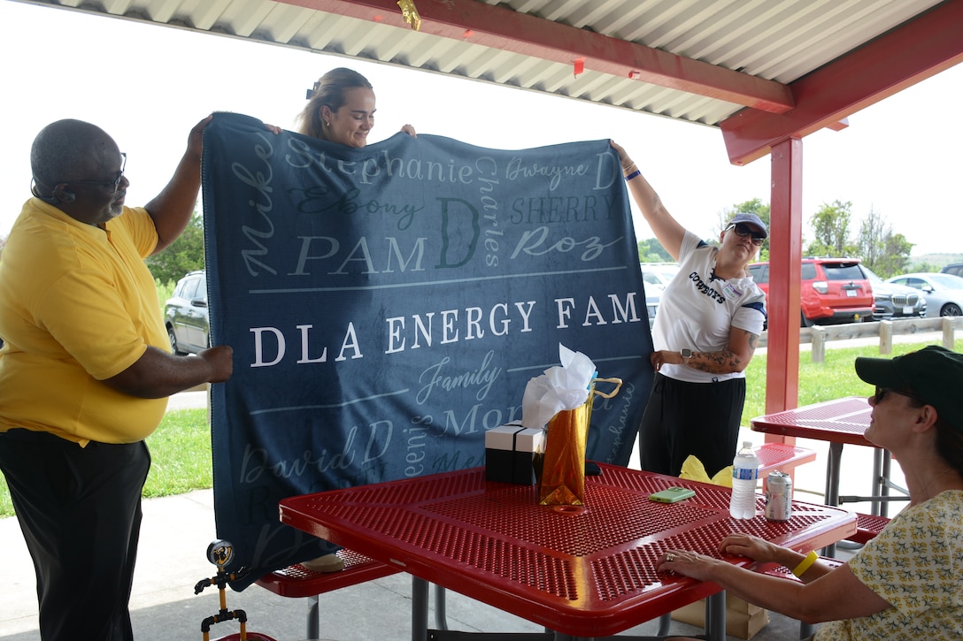 Woman displays blanket with names