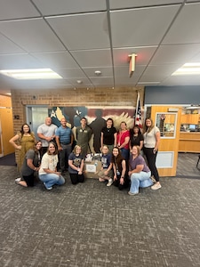 Members of the Arnold Engineering Development Complex 719th Test Squadron at Hill Air Force Base, Utah, deliver school supplies to Hill Field Elementary in Clearfield, Utah, Aug. 12, 2025. Members of the 719 TS collected and delivered supplies to two local schools to kick off the 2025-26 school year. Members of the squadron pictured are 719 TS Resource Specialist Marissa Gutierrez, standing left, Intel Project Manager Kyle Romney, standing second from left, Technical Management and Advisory Services Group Lead Trevor Foust, standing third from left, Director of Intercontinental Ballistic Missile Flight Test Maj. Mike Macchia, standing fourth from left, and Squadron Personnel/Manpower Specialist Ashley Jordan, standing fifth from left. Also pictured are school staff and teachers who accepted the supplies. (Courtesy photo)