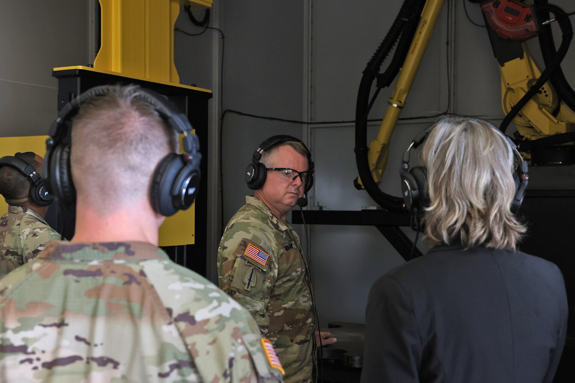 Lt. Gen. Chris Mohan (center), Army Materiel Command deputy commanding general and AMC acting commander, receives an update on the new robotic weld arm from Kate Williams (right), Letterkenny Army Depot Directorate of Strategic Management director, during a tour of the depot on August 12.