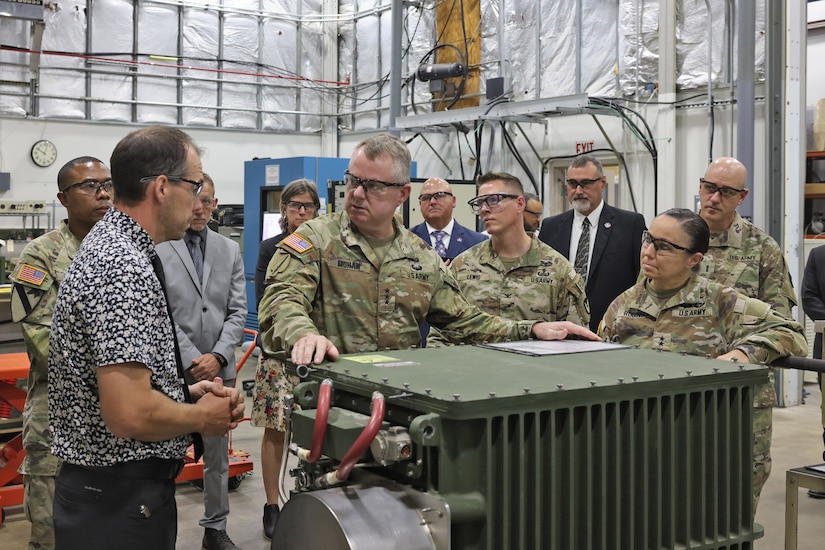 Zachary Rodgers (left), Letterkenny Army Depot Chassis Test and Reconditioning Branch chief, briefs Lt. Gen. Chris Mohan (front center), Army Materiel Command deputy commanding general and AMC acting commander, and Maj. Gen. Lori Robinson (front right), Army Aviation and Missile Command commanding general, during a visit to the depot on August 12.