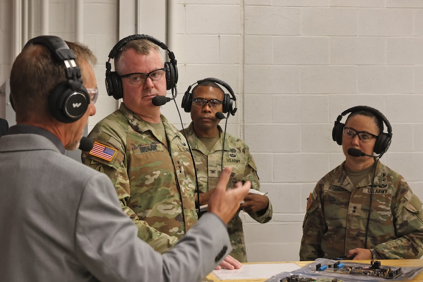 Dale McClanahan (left), Letterkenny Army Depot Future Systems Integration Office chief, briefs Lt. Gen. Chris Mohan (left center), Army Materiel Command deputy commanding general and AMC acting commander, and Maj. Gen. Lori Robinson (right), Army Aviation and Missile Command commanding general, during a visit to the depot on August 12.