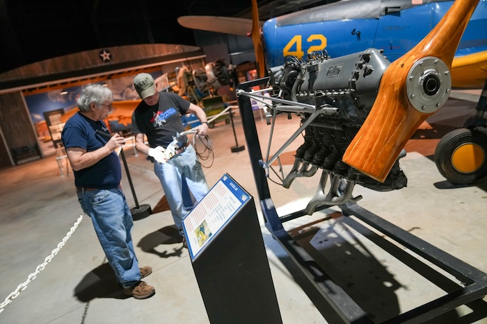 Men working on aircraft  engine