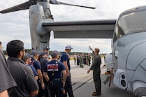 U.S. Marines and civilians from Marine Corps Air Station (MCAS) New River and Marine Medium Tiltrotor Squadron (VMM) 365 examine the exterior of an MV-22B Osprey alongside first responders from neighboring communities during an aircraft mishap exercise at Marine Corps Outlying Landing Field Camp Davis on Marine Corps Base Camp Lejeune, North Carolina, Aug. 28, 2025.