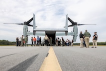 U.S. Marines and civilians from Marine Corps Air Station (MCAS) New River and Marine Medium Tiltrotor Squadron (VMM) 365 examine the exterior of an MV-22B Osprey alongside first responders from neighboring communities during an aircraft mishap exercise at Marine Corps Outlying Landing Field Camp Davis on Marine Corps Base Camp Lejeune, North Carolina, Aug. 28, 2025.
