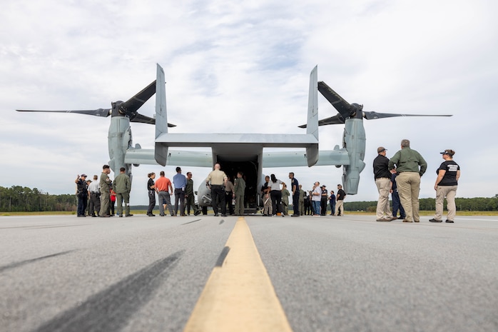 U.S. Marines and civilians from Marine Corps Air Station (MCAS) New River and Marine Medium Tiltrotor Squadron (VMM) 365 examine the exterior of an MV-22B Osprey alongside first responders from neighboring communities during an aircraft mishap exercise at Marine Corps Outlying Landing Field Camp Davis on Marine Corps Base Camp Lejeune, North Carolina, Aug. 28, 2025.