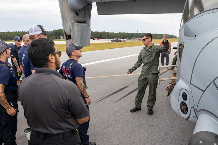 U.S. Marine Corps Sgt. Isaac J. Dziadzio, a P-19 vehicle operator with Marine Wing Support Squadron 272, Marine Aircraft Group 26, 2nd Marine Aircraft Wing, instructs civilian first responders from neighboring communities during an aircraft mishap exercise at Marine Corps Outlying Landing Field Camp Davis on Marine Corps Base Camp Lejeune, North Carolina, Aug. 28, 2025.