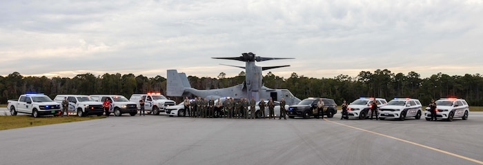 U.S. Marines and civilians from Marine Corps Air Station (MCAS) New River and Marine Medium Tiltrotor Squadron (VMM) 365 pose for a photo with first responders from neighboring communities after an aircraft mishap exercise at Marine Corps Outlying Landing Field Camp Davis on Marine Corps Base Camp Lejeune, North Carolina, Aug. 28, 2025.
