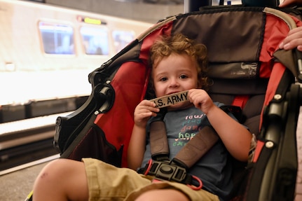 A child holds an Army nametape at Metro Center station in Washington, D.C., on August 23, 2025. Approximately 2,200 National Guard service members comprise JTF-DC to support the DC Safe and Beautiful Taskforce. These National Guard service members provide critical support such as crowd management, perimeter control, logistics and communications in support of law enforcement.