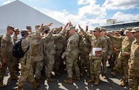 U.S. Army Lt. Gen. Jonathan Stubbs, center, director, Army National Guard, brings Guardsmen in for a motivational moment as they prepare to go on shift as part of the D.C. Safe and Beautiful Task Force at the Logistical Support Area on Joint Base Anacostia-Bolling Aug. 25, 2025. About 2,000 National Guard members are supporting the D.C. Safe and Beautiful mission providing critical support to the D.C. Metropolitan Police Department in ensuring the safety of all who live, work and visit the District.