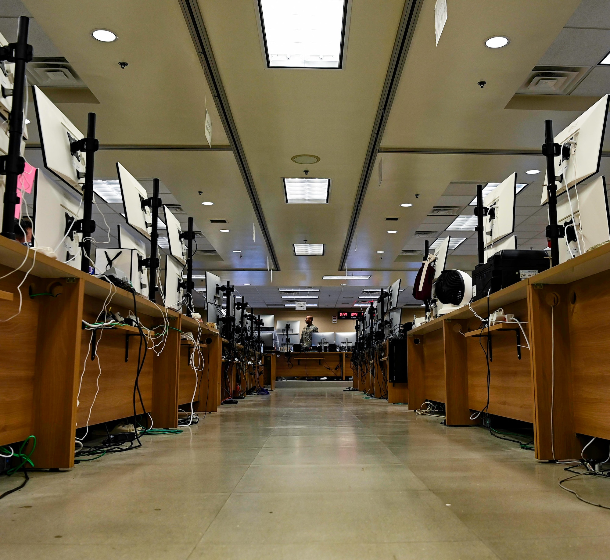 A photo of a walkway lined with computers