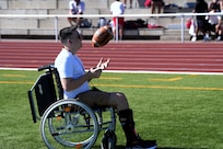 Kaiserslautern High School student Aiden, center, sits with his family and Staff Sgt. Stephen Burkham, right, and Lt. Col. Juanita Dubo, top, after returning to the football field months after a medical emergency during a game. Burkham and Dubon, both Army Reserve Soldiers, are credited with saving Aiden’s life through their volunteer medical support.