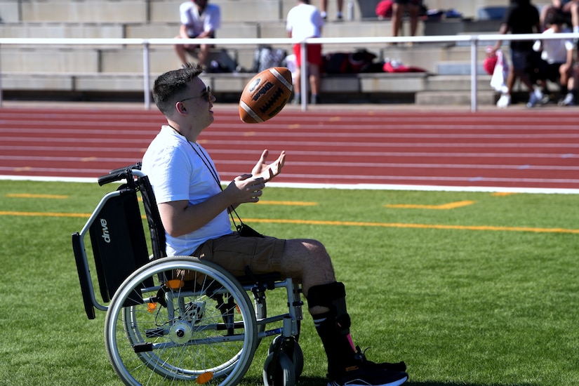 Kaiserslautern High School student Aiden, center, sits with his family and Staff Sgt. Stephen Burkham, right, and Lt. Col. Juanita Dubo, top, after returning to the football field months after a medical emergency during a game. Burkham and Dubon, both Army Reserve Soldiers, are credited with saving Aiden’s life through their volunteer medical support.