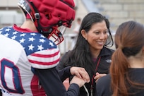 Lt. Col. Juanita Dubon, an Army nurse practitioner, volunteers with Kaiserslautern High School athletes during a football practice in Kaiserslautern, Germany. Dubon, along with Staff Sgt. Stephen Burkham, is credited with saving a student’s life during a game last fall.