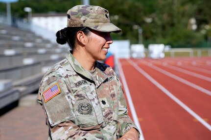 Lt. Col. Juanita Dubon, an Army nurse practitioner, volunteers with Kaiserslautern High School athletes during a football practice in Kaiserslautern, Germany. Dubon, along with Staff Sgt. Stephen Burkham, is credited with saving a student’s life during a game last fall.