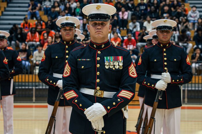 U.S. Marine Corps Staff Sgt. Zackery Cox, platoon sergeant, United States Marine Corps Silent Drill Platoon, stands at "ceremonial at-ease" before a performance for the students of Parkview High School during Marine Week Atlanta in Lilburn, Ga., Aug. 29, 2025. The year 2025 marks the 250th anniversary of the United States Marine Corps, a milestone that highlights the legacy, transformation and enduring spirit of the Corps since 1775. Throughout the year, Marines across the globe will commemorate this anniversary by honoring the service and sacrifice of those who served before them and by remaining faithful to the motto Semper Fidelis. (U.S. Marine Corps photo by Cpl. Christopher Prelle)