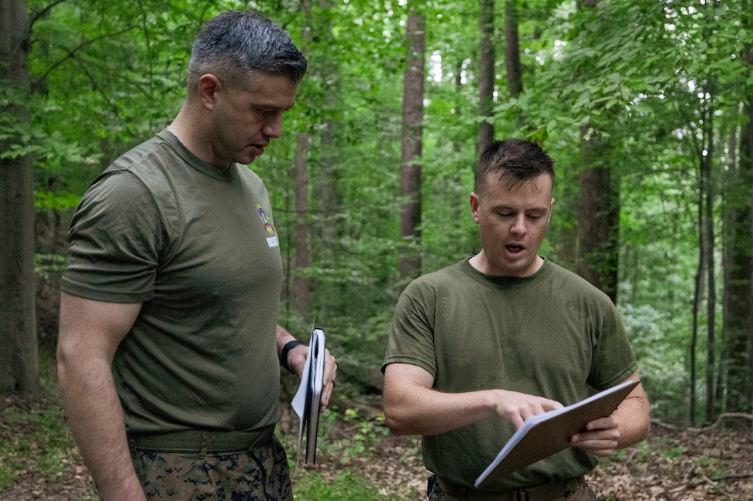 U.S. Marine Corps 1st Lt. Andrew Comstock, right, a student assigned to Expeditionary Warfare School, Marine Corps University, briefs a tactical decision to U.S. Marine Corps Maj. Tyler Simmons, the planning course director for EWS, during Leadership Decision Making Exercise I at Marine Corps Base Quantico, Virginia, Aug. 22, 2025. Students at EWS participated in decision-forcing cases based on the Battle of Belleau Wood combined with physical training exercises to increase problem-solving skills under pressure. Comstock is a native of Ohio. Simmons is a native of Oklahoma. (U.S. Marine Corps photo by Capt. Colton Martin)