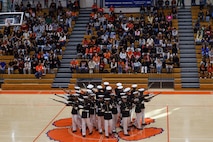 U.S. Marines with the United States Marine Corps Silent Drill Platoon execute their "bursting bomb" sequence during a performance for the students of Parkview High School during Marine Week Atlanta in Lilburn, Ga., Aug. 29, 2025. The year 2025 marks the 250th anniversary of the United States Marine Corps, a milestone that highlights the legacy, transformation and enduring spirit of the Corps since 1775. Throughout the year, Marines across the globe will commemorate this anniversary by honoring the service and sacrifice of those who served before them and by remaining faithful to the motto Semper Fidelis. (U.S. Marine Corps photo by Cpl. Christopher Prelle)