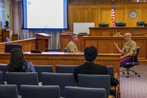 U.S. Marine Corps Col. James Gallagher, left, a judge advocate with Marine Forces Command, and Lt. Col. Brad Tully, right, a deputy judge advocate with Headquarters and Service Battalion, Marine Corps Recruit Depot Parris Island, demonstrate how a judge advocate might advise a commander on legal issues for law students at Suffolk University Law School during Marine Week Boston, Aug. 25, 2025. During Marine Week Boston, Marines with Marine Corps Recruiting Command shared Marine Corps traditions and opportunities with the local community. (U.S. Marine Corps photo by Sgt. Aidan Hekker)