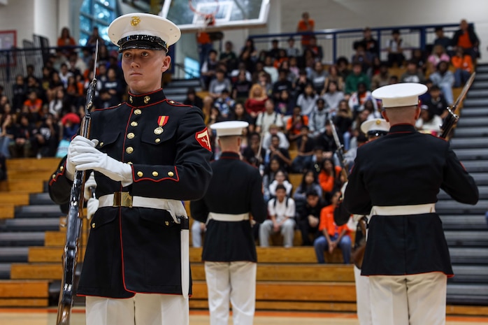 U.S. Marines with the United States Marine Corps Silent Drill Platoon execute their "long line" sequence during a performance for the students of Parkview High School during Marine Week Atlanta in Lilburn, Ga., Aug. 29, 2025. The year 2025 marks the 250th anniversary of the United States Marine Corps, a milestone that highlights the legacy, transformation and enduring spirit of the Corps since 1775. Throughout the year, Marines across the globe will commemorate this anniversary by honoring the service and sacrifice of those who served before them and by remaining faithful to the motto Semper Fidelis. (U.S. Marine Corps photo by Cpl. Christopher Prelle)