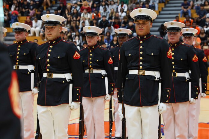 U.S. Marines with the United States Marine Corps Silent Drill Platoon stand at attention during a performance for the students of Parkview High School during Marine Week Atlanta in Lilburn, Ga., Aug. 29, 2025. The year 2025 marks the 250th anniversary of the United States Marine Corps, a milestone that highlights the legacy, transformation and enduring spirit of the Corps since 1775. Throughout the year, Marines across the globe will commemorate this anniversary by honoring the service and sacrifice of those who served before them and by remaining faithful to the motto Semper Fidelis. (U.S. Marine Corps photo by Cpl. Christopher Prelle)