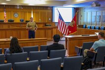 U.S. Marine Corps Capt. Tyler Pittman, a military justice instructor with Marine Detachment Newport, briefs law students at Suffolk University Law School about judge advocate specializations during Marine Week Boston, Aug. 25, 2025. During Marine Week Boston, Marines with Marine Corps Recruiting Command shared Marine Corps traditions and opportunities with the local community. (U.S. Marine Corps photo by Sgt. Aidan Hekker)