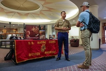 U.S. Marine Corps Sgt. Ernesto Vasquez, an officer selection assistant with Recruiting Station Boston, 1st Marine Corps District, discusses officer programs with a law student at Suffolk University Law School during Marine Week Boston, Aug. 25, 2025. During Marine Week Boston, Marines with Marine Corps Recruiting Command shared Marine Corps traditions and opportunities with the local community. (U.S. Marine Corps photo by Sgt. Aidan Hekker)