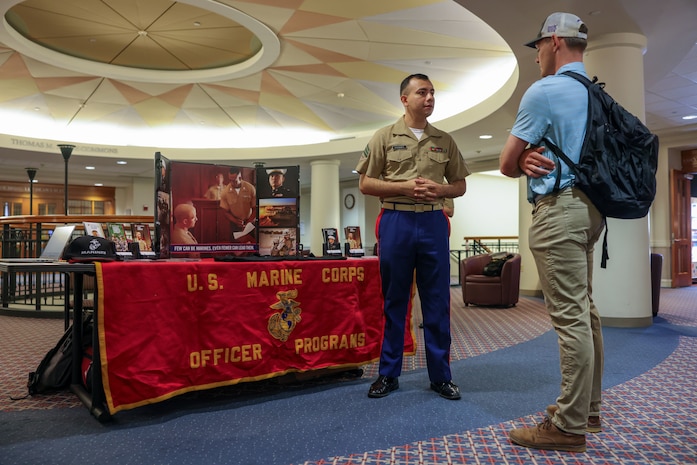 U.S. Marine Corps Sgt. Ernesto Vasquez, an officer selection assistant with Recruiting Station Boston, 1st Marine Corps District, discusses officer programs with a law student at Suffolk University Law School during Marine Week Boston, Aug. 25, 2025. During Marine Week Boston, Marines with Marine Corps Recruiting Command shared Marine Corps traditions and opportunities with the local community. (U.S. Marine Corps photo by Sgt. Aidan Hekker)