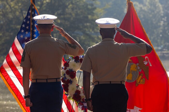 U.S. Marine Corps Brig. Gen. Ahmed T. Williamson, commanding general of Marine Corps Recruit Depot Paris Island and Eastern Recruiting Region, right, and Sgt. Maj. Carlos A. Ruiz, the 20th Sergeant Major of the Marine Corps, salute during taps at a wreath laying ceremony held by Special Purpose Marine Air-Ground Task Force-250 at Piedmont Park during Marine Week Atlanta, Aug. 30, 2025. The solemn tribute served to commemorate Marines who made the ultimate sacrifice in defense of our nation during Operations Iraqi and Enduring Freedom. Marines stationed across the globe commemorate the 250th anniversary of the Marine Corps, honoring a distinguished legacy of service, sacrifice, and unwavering fidelity to both the nation and fellow Marines. (U.S. Marine Corps photo by Lance Cpl. Isabella Ramos)