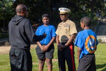 U.S. Marine Corps Brig. Gen. Ahmed T. Williamson, commanding general of Marine Corps Recruit Depot Paris Island and Eastern Recruiting Region, speaks with civilians during a wreath laying ceremony held by Special Purpose Marine Air-Ground Task Force-250 at Piedmont Park during Marine Week Atlanta, Aug. 30, 2025. The solemn tribute served to commemorate Marines who made the ultimate sacrifice in defense of our nation during Operations Iraqi and Enduring Freedom. Marines stationed across the globe commemorate the 250th anniversary of the Marine Corps, honoring a distinguished legacy of service, sacrifice, and unwavering fidelity to both the nation and fellow Marines. (U.S. Marine Corps photo by Lance Cpl. Isabella Ramos)