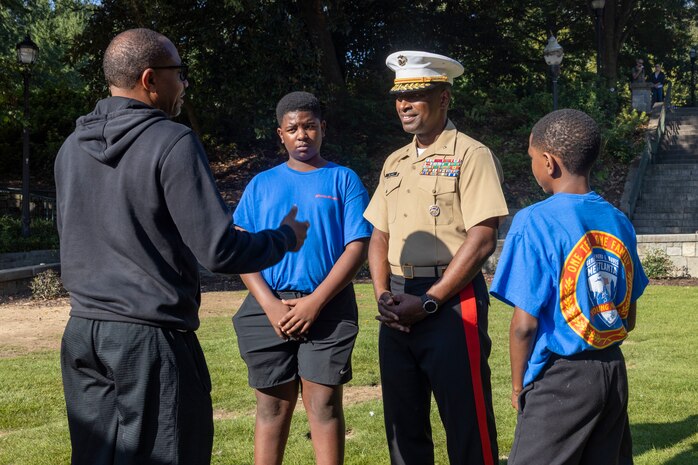 U.S. Marine Corps Brig. Gen. Ahmed T. Williamson, commanding general of Marine Corps Recruit Depot Paris Island and Eastern Recruiting Region, speaks with civilians during a wreath laying ceremony held by Special Purpose Marine Air-Ground Task Force-250 at Piedmont Park during Marine Week Atlanta, Aug. 30, 2025. The solemn tribute served to commemorate Marines who made the ultimate sacrifice in defense of our nation during Operations Iraqi and Enduring Freedom. Marines stationed across the globe commemorate the 250th anniversary of the Marine Corps, honoring a distinguished legacy of service, sacrifice, and unwavering fidelity to both the nation and fellow Marines. (U.S. Marine Corps photo by Lance Cpl. Isabella Ramos)
