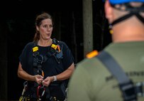Jessica Kilgallen, the director of events and hospitality at Camp Southern Ground, teaches rope safety to U.S. Marines assigned to Special Purpose Marine Air-Ground Task Force 250 and Young Marines from Middle Georgia Young Marines Program for the confidence course at Camp Southern Ground, Fayetteville, Georgia during Marine Week Atlanta, Aug. 30, 2025. Marines stationed across the globe commemorate the 250th anniversary of the Marine Corps, honoring a distinguished legacy of service, sacrifice, and unwavering fidelity to both the nation and the Corps. (U.S. Marine Corps photo by Sgt. Alexis French)