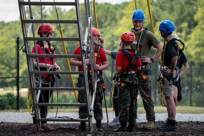 U.S. Marine Corps Capt. Jack Nance, an infantry officer assigned to Special Purpose Marine Air-Ground Task Force 250, and Young Marines from Middle Georgia Young Marines Program take part in the confidence course at Camp Southern Ground, Fayetteville, Georgia during Marine Week Atlanta, Aug. 30, 2025. Marines stationed across the globe commemorate the 250th anniversary of the Marine Corps, honoring a distinguished legacy of service, sacrifice, and unwavering fidelity to both the nation and the Corps. (U.S. Marine Corps photo by Sgt. Alexis French)