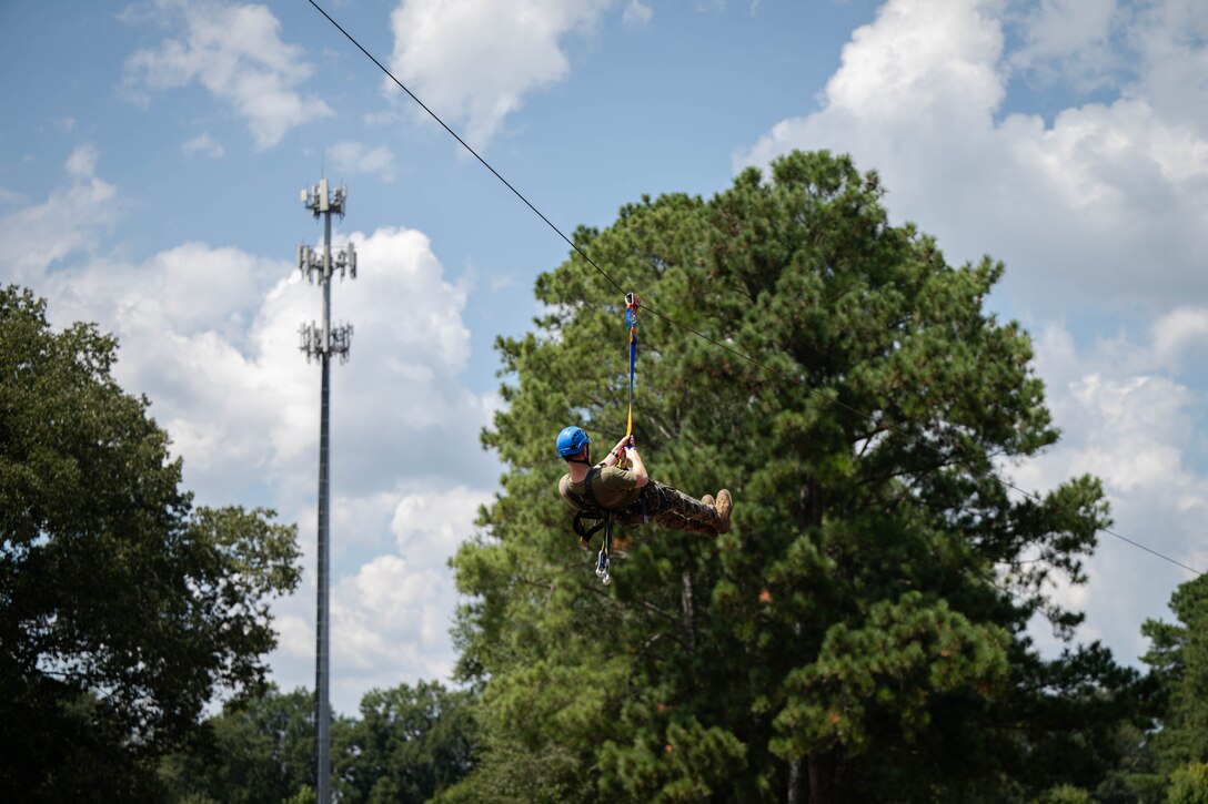 U.S. Marine Corps Capt. Jack Nance, an infantry officer assigned to Special Purpose Marine Air-Ground Task Force 250 ziplines as a part of the confidence course at Camp Southern Ground, Fayetteville, Georgia during Marine Week Atlanta, Aug. 30, 2025. Marines stationed across the globe commemorate the 250th anniversary of the Marine Corps, honoring a distinguished legacy of service, sacrifice, and unwavering fidelity to both the nation and the Corps. (U.S. Marine Corps photo by Sgt. Alexis French)