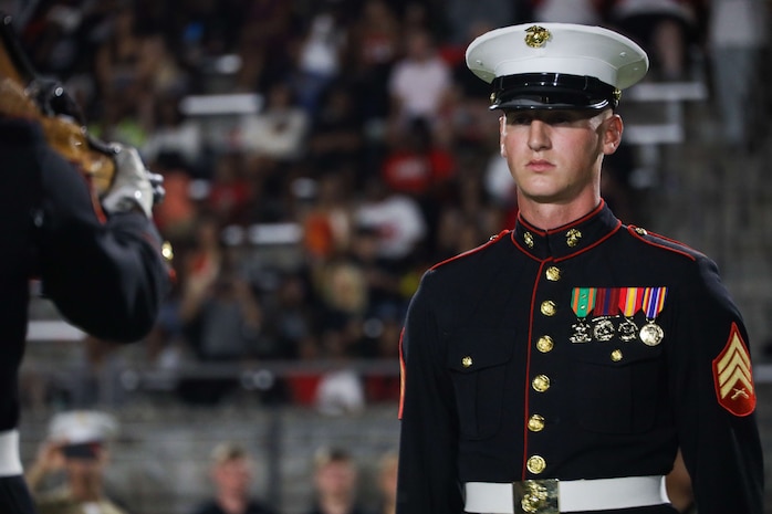 U.S. Marine Corps Sgt. William Buffington, rifle inspector, United States Marine Corps Silent Drill Platoon, executes the "rifle inspection" sequence during a half-time performance at a Gainesville High School football game during Marine Week Atlanta in Gainesville, Ga., Aug. 29, 2025. The year 2025 marks the 250th anniversary of the United States Marine Corps, a milestone that highlights the legacy, transformation and enduring spirit of the Corps since 1775. Throughout the year, Marines across the globe will commemorate this anniversary by honoring the service and sacrifice of those who served before them and by remaining faithful to the motto Semper Fidelis. (U.S. Marine Corps photo by Cpl. Christopher Prelle)