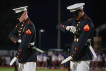 U.S. Marine Corps Lance Cpl. Kyle Uhlar and Cpl. Jacob Dobromirescu, riflemen with the United States Marine Corps Silent Drill Platoon, execute the "double inspection" sequence during a half-time performance at a Gainesville High School football game during Marine Week Atlanta in Gainesville, Ga., Aug. 29, 2025. The year 2025 marks the 250th anniversary of the United States Marine Corps, a milestone that highlights the legacy, transformation and enduring spirit of the Corps since 1775. Throughout the year, Marines across the globe will commemorate this anniversary by honoring the service and sacrifice of those who served before them and by remaining faithful to the motto Semper Fidelis. (U.S. Marine Corps photo by Cpl. Christopher Prelle)
