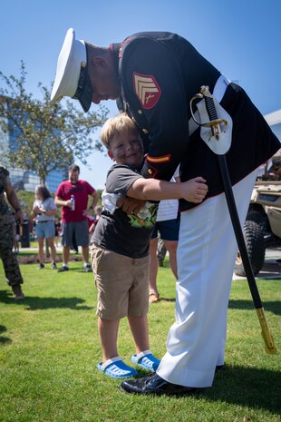 A U.S. Marine with Silent Drill Platoon with Marine Barracks Washington hugs a child during Marine Week Atlanta, Aug. 31, 2025. Marines stationed across the globe commemorate the 250th anniversary of the Marine Corps, honoring a distinguished legacy of service, sacrifice, and unwavering fidelity to both the nation and the Corps. (U.S. Marine Corps photo by Sgt. Alfonso Livrieri)