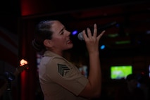 U.S. Marine Corps Sgt. Elizabeth Marino, a vocalist with the 2D Marine Aircraft Wing Band with the popular music group, assigned to Special Purpose Marine Air-Ground Task Force-250 performs at Cobb County, Georgia during Marine Week Atlanta, Aug. 30, 2025. Marines stationed across the globe commemorate the 250th anniversary of the Marine Corps, honoring a distinguished legacy of service, sacrifice, and unwavering fidelity to both the nation and the Corps. (U.S. Marine Corps photo by Lance Cpl. Steven Wells)