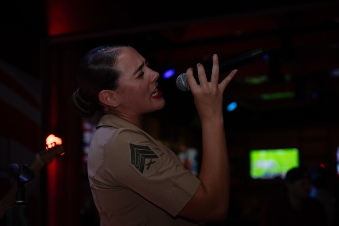 U.S. Marine Corps Sgt. Elizabeth Marino, a vocalist with the 2D Marine Aircraft Wing Band with the popular music group, assigned to Special Purpose Marine Air-Ground Task Force-250 performs at Cobb County, Georgia during Marine Week Atlanta, Aug. 30, 2025. Marines stationed across the globe commemorate the 250th anniversary of the Marine Corps, honoring a distinguished legacy of service, sacrifice, and unwavering fidelity to both the nation and the Corps. (U.S. Marine Corps photo by Lance Cpl. Steven Wells)