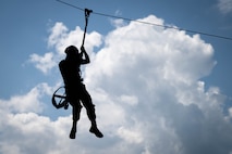 A U.S. Marine assigned to Special Purpose Marine Air-Ground Task Force 250 ziplines as a part of the confidence course at Camp Southern Ground, Fayetteville, Georgia during Marine Week Atlanta, Aug. 30, 2025. Marines stationed across the globe commemorate the 250th anniversary of the Marine Corps, honoring a distinguished legacy of service, sacrifice, and unwavering fidelity to both the nation and the Corps. (U.S. Marine Corps photo by Sgt. Alexis French)