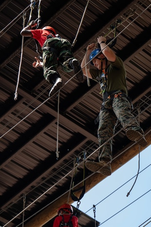 U.S. Marine Corps Capt. Jack Nance, an infantry officer assigned to Special Purpose Marine Air-Ground Task Force 250, and Young Marines from Middle Georgia Young Marines Program take part in the confidence course at Camp Southern Ground, Fayetteville, Georgia during Marine Week Atlanta, Aug. 30, 2025. Marines stationed across the globe commemorate the 250th anniversary of the Marine Corps, honoring a distinguished legacy of service, sacrifice, and unwavering fidelity to both the nation and the Corps. (U.S. Marine Corps photo by Sgt. Alexis French)