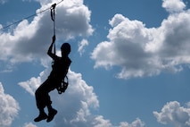U.S. Marine Corps Lance Cpl. Cristian RojasRamos, a ground electronics transmission systems maintainer assigned to Combat Logistics Regiment 45, zip lines off of the confidence course at Camp Southern Ground during Marine Week Atlanta, Aug. 30, 2025. Marines stationed across the globe commemorate the 250th anniversary of the Marine Corps, honoring a distinguished legacy of the service, sacrifice, and unwavering fidelity to both the nation and fellow Marines. (U.S. Marine Corps photo by Lance Cpl. Matthew A. McDonnell)