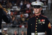 U.S. Marine Corps Sgt. William Buffington, rifle inspector, United States Marine Corps Silent Drill Platoon, executes the "rifle inspection" sequence during a half-time performance at a Gainesville High School football game during Marine Week Atlanta in Gainesville, Ga., Aug. 29, 2025. The year 2025 marks the 250th anniversary of the United States Marine Corps, a milestone that highlights the legacy, transformation and enduring spirit of the Corps since 1775. Throughout the year, Marines across the globe will commemorate this anniversary by honoring the service and sacrifice of those who served before them and by remaining faithful to the motto Semper Fidelis. (U.S. Marine Corps photo by Cpl. Christopher Prelle)