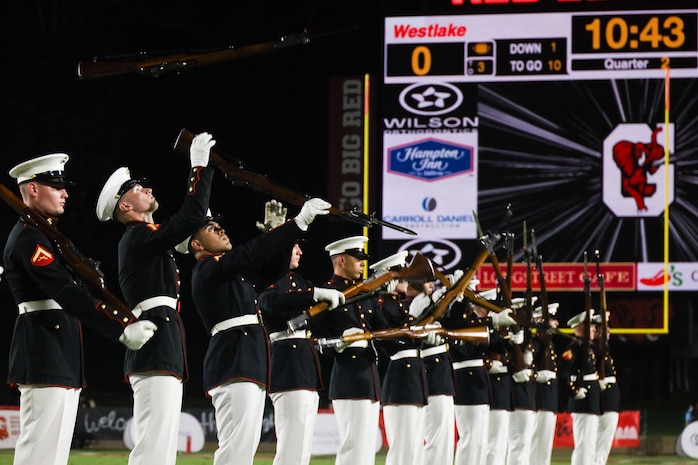 U.S. Marines with the United States Marine Corps Silent Drill Platoon execute their "long line" sequence during a half-time performance at a Gainesville High School football game during Marine Week Atlanta in Gainesville, Ga., Aug. 29, 2025. The year 2025 marks the 250th anniversary of the United States Marine Corps, a milestone that highlights the legacy, transformation and enduring spirit of the Corps since 1775. Throughout the year, Marines across the globe will commemorate this anniversary by honoring the service and sacrifice of those who served before them and by remaining faithful to the motto Semper Fidelis. (U.S. Marine Corps photo by Cpl. Christopher Prelle)