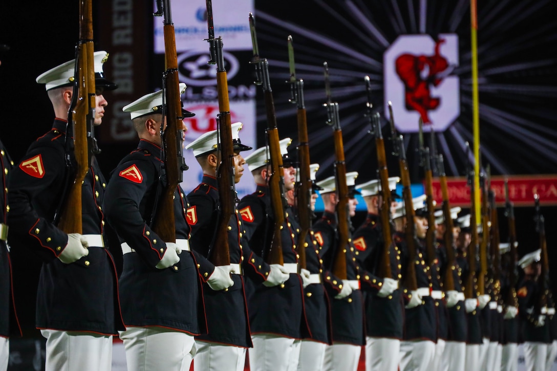 U.S. Marines with the United States Marine Corps Silent Drill Platoon execute their "long line" sequence during a half-time performance at a Gainesville High School football game during Marine Week Atlanta in Gainesville, Ga., Aug. 29, 2025. The year 2025 marks the 250th anniversary of the United States Marine Corps, a milestone that highlights the legacy, transformation and enduring spirit of the Corps since 1775. Throughout the year, Marines across the globe will commemorate this anniversary by honoring the service and sacrifice of those who served before them and by remaining faithful to the motto Semper Fidelis. (U.S. Marine Corps photo by Cpl. Christopher Prelle)