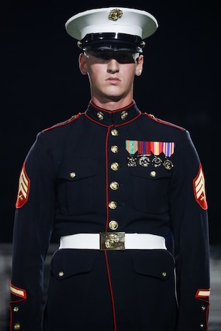U.S. Marine Corps Sgt. William Buffington, rifle inspector, United States Marine Corps Silent Drill Platoon, stands at attention during a half-time performance at a Gainesville High School football game during Marine Week Atlanta in Gainesville, Ga., Aug. 29, 2025. The year 2025 marks the 250th anniversary of the United States Marine Corps, a milestone that highlights the legacy, transformation and enduring spirit of the Corps since 1775. Throughout the year, Marines across the globe will commemorate this anniversary by honoring the service and sacrifice of those who served before them and by remaining faithful to the motto Semper Fidelis. (U.S. Marine Corps photo by Cpl. Christopher Prelle)