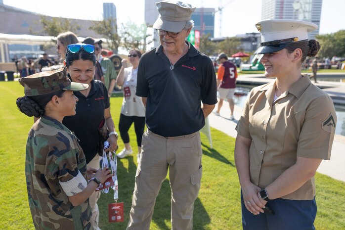 U.S. Marine Corps Lance Cpl. Abigail Hutcheson, a combat graphics specialist with the Communication Directorate, Headquarters Marine Corps, talks with a member of the Young Marines Program during Marine Week Atlanta, Aug. 31, 2025. Marines stationed across the globe commemorate the 250th anniversary of the Marine Corps, honoring a distinguished legacy of service, sacrifice, and unwavering fidelity to both the nation and fellow Marines. (U.S. Marine Corps photo by Lance Cpl. Kiara Rawls)